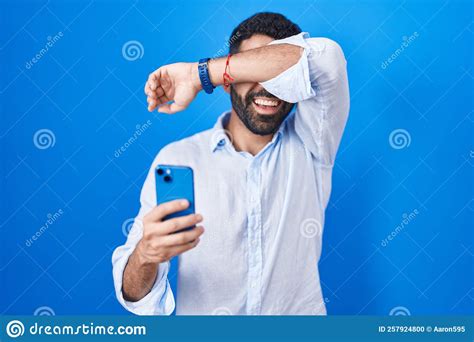 Hispanic Man With Beard Using Smartphone Typing Message Smiling