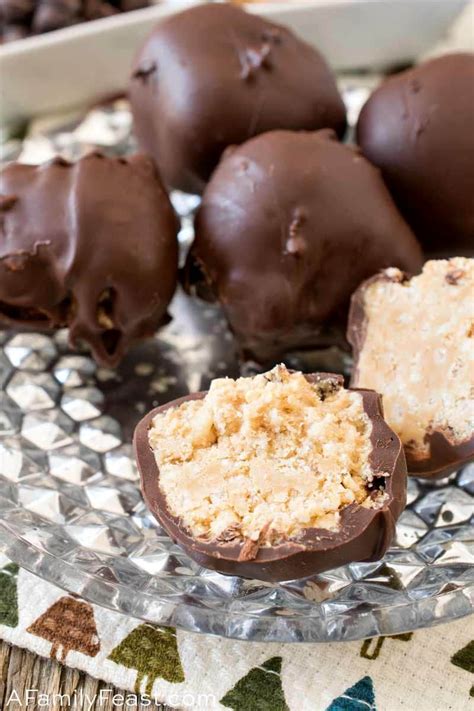 Chocolate Covered Peanut Butter Balls On A Glass Plate