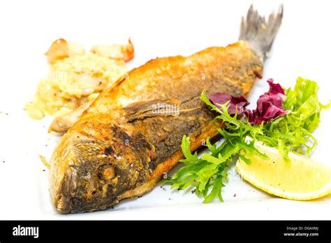 Fried Fish Dorado With Vegetables And Lemon Stock Photo Alamy