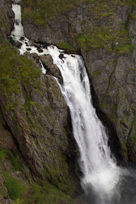 Large Waterfall Flowing Over A Lush Green Hillside Stock Photo Image