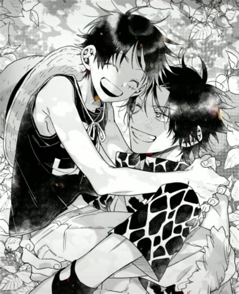 An Anime Couple Kissing In Front Of Flowers