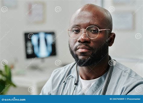 Young Serious African American Male General Practitioner In Blue