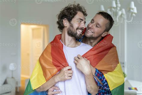Affectionate Male Gay Couple Indoors Man Embracing His Boyfriend From