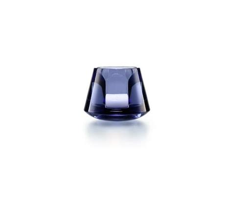 A Blue Glass Vase Sitting On Top Of A White Table