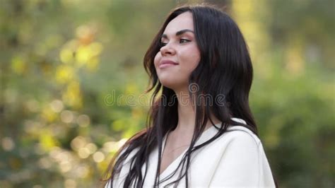 Portrait Of Attractive Smiling Caucasian Brunette Woman Is Looking In