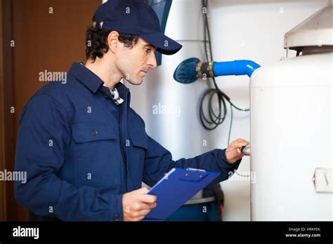 Smiling Technician Repairing An Hot Water Heater Stock Photo Alamy