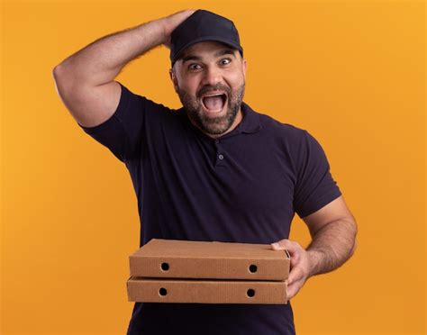 Free Photo Surprised Middle Aged Delivery Man In Uniform And Cap