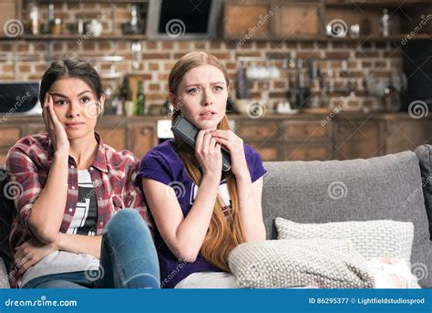 Women Sitting On Sofa And Watching Tv Stock Image Image Of Girls