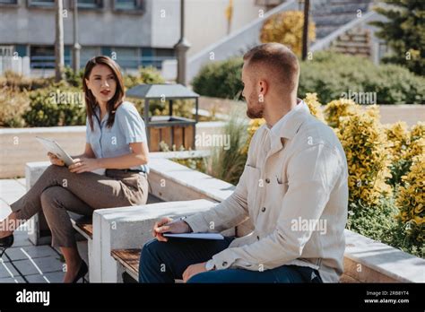 Beautiful Female Employees Talking To Their New Male Colleague To Get Know Each Other Better