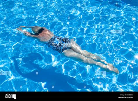 Female Swimming Underwater In Pool Stock Photo Alamy