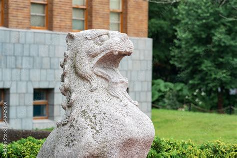 traditional Japanese statue of a stone lion at the entrance to the ...