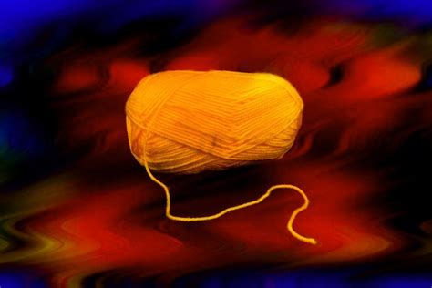 Premium Photo A Ball Of Yellow Yarn On A Black Background Ball Of