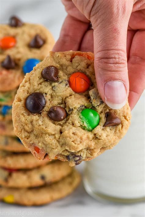 A Hand Holding Up A Cookie With M M Cookies