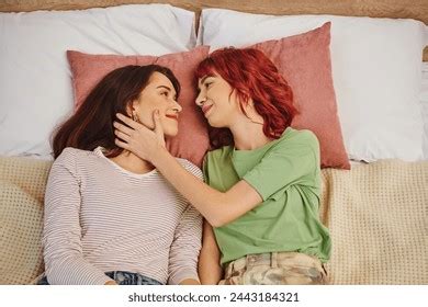 Стоковая фотография 2443184321 Top View Smiling Lesbian Couple Looking