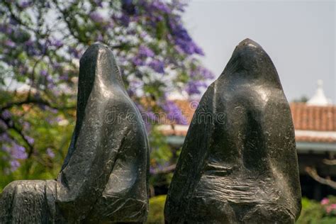 Esculturas De Dos Formas Humanas De Piedra Negra En Un Parque Imagen De