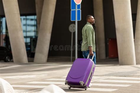 African Traveler Man Walking With Suitcase Through Crosswalk Near