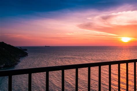 View Of Sunset The Balcony In The Sea With Clouds And Water Reflection