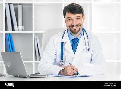 Portrait Of Smiling Mature Doctor In A Clinical Office Stock Photo Alamy