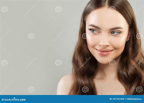 Portrait Of Cheerful Woman With Clear Skin And Healthy Curly Hair On