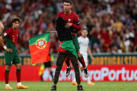 Cristiano Ronaldo lifted by fan who ran onto field during Portugal win