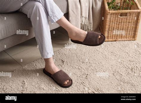 Man Sitting On Sofa In Soft Slippers Stock Photo Alamy