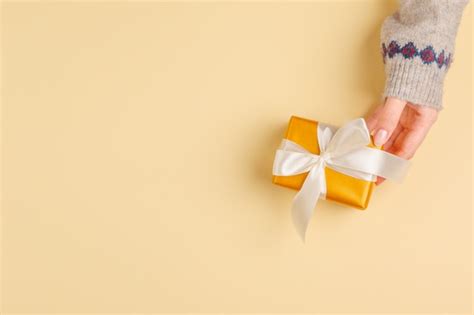 Premium Photo Top View Of Woman Hands Holding Gift Box