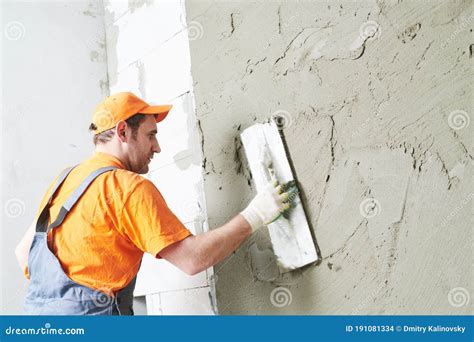 Renovation At Home Plasterer Smoothing Plaster On Wall Stock Photo