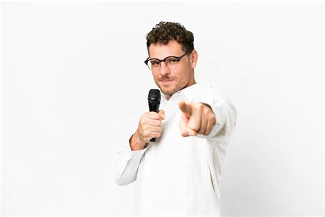 Premium Photo Brazilian Man Picking Up A Microphone Over Isolated