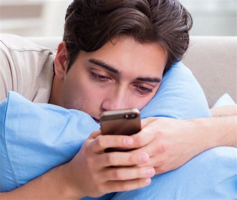 Man Addicted To His Mobile Phone In Bed Stock Image Image Of