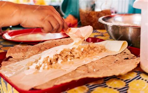 Premium Photo | Hands making Nicaraguan Quesillo Central American food ...