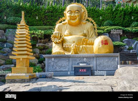 A golden Buddha at Haedong Yonggungsa Temple, a Buddhist temple in Busan, South Korea Stock ...