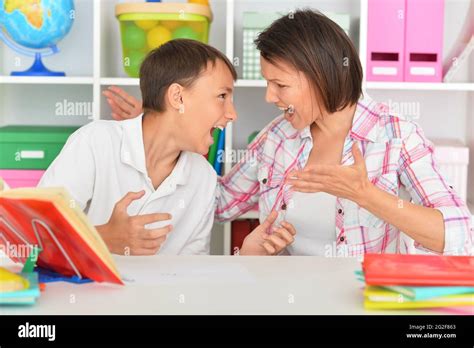 Emotional Mother With Her Son Doing Homework At Home Stock Photo Alamy