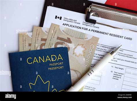 Application For Permanent Resident Card On Table With Pen And Canadian