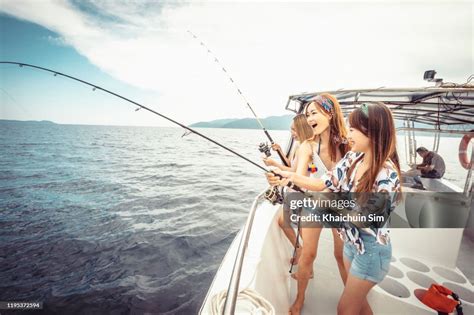 Asian Girls Fishing On A Boat High Res Stock Photo Getty Images