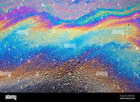 Multi Colored Oil Spill On Asphalt Road Abstract Background Stock