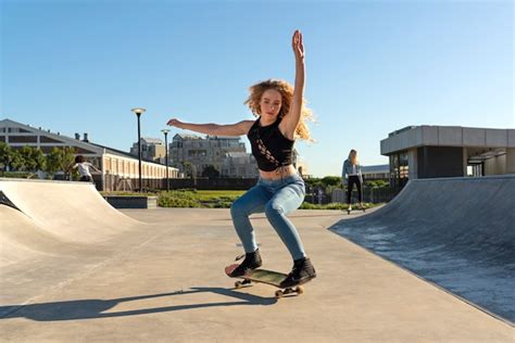 Free Photo | Girl doing tricks on skateboard full shot