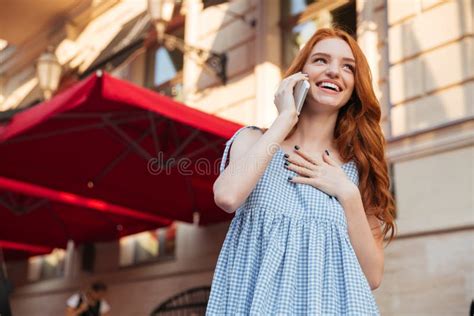 Smiling Attractive Girl With Long Hair Talking On Mobile Phone Stock