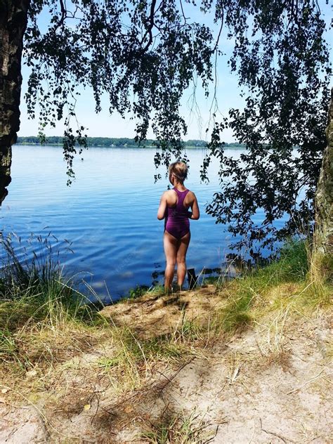 Premium Photo Rear View Of Girl In Swimwear Standing At Lakeshore