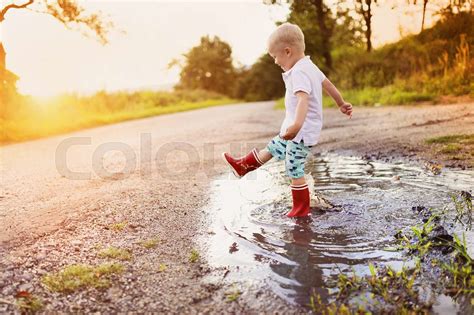 Boy In A Puddle Stock Image Colourbox