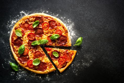 Traditional Italian Pizza With Salami Cheese Tomatoes And Basil Stock