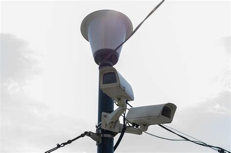 Premium Photo Surveillance Cameras Mounted On A Lamp Post Against A