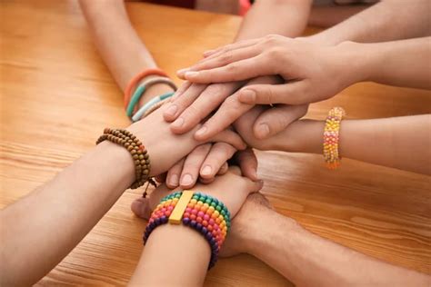 People Putting Hands Together As Symbol Of Unity On White Background