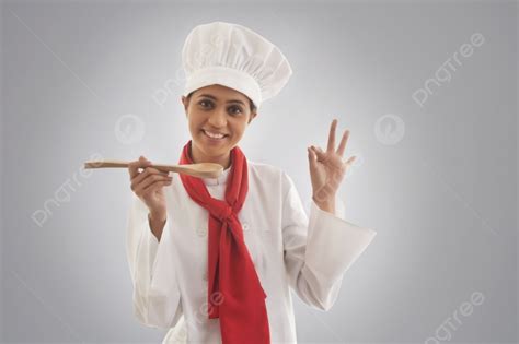 Portrait Of Young Female Chef Gesturing Ok Sign Photo Background And