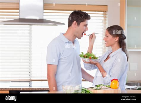 Happy Couple Tasting A Salad Stock Photo Alamy