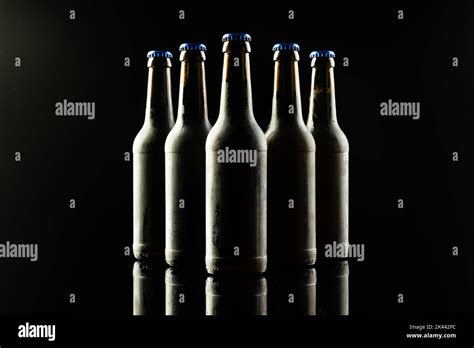 Horizontal Image Of Five Dark Glass Bottles Of Lager Beer With Blue