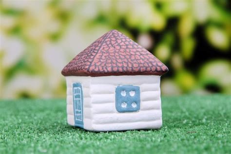 Premium Photo Little House On Green Grass On Bright Background