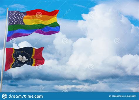 Large Us Lgbtqflag And Flag Of Mississippi State Usa Waving In Wind At