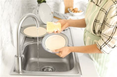 Premium Photo Woman Washing Dishes In Kitchen Sink