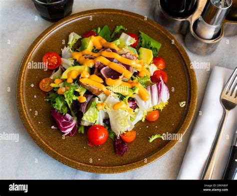 Tuna salad with vegetables and Anticucho sauce Stock Photo - Alamy