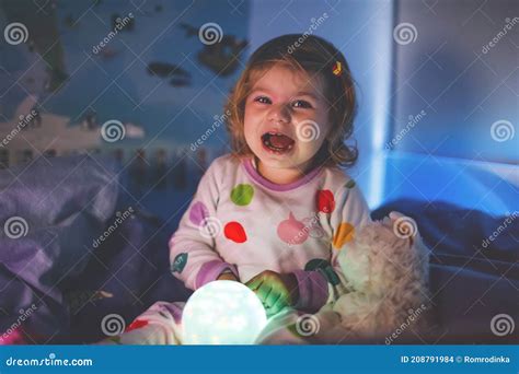 Toddler Scared And Climb Up Under The Bed Small Child`s Feet On Floor